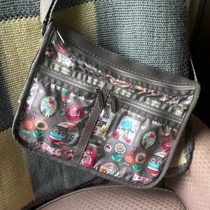 Lesportsac Deluxe Everyday Bag in “Keep Happy” print with matching pouch